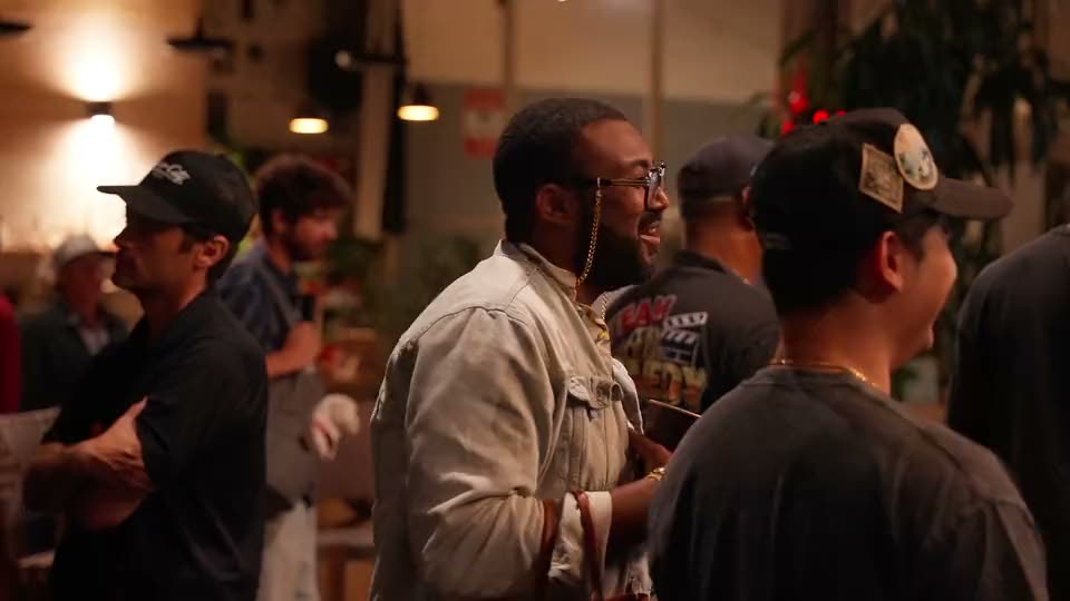 A guest laughing in the evening crowd